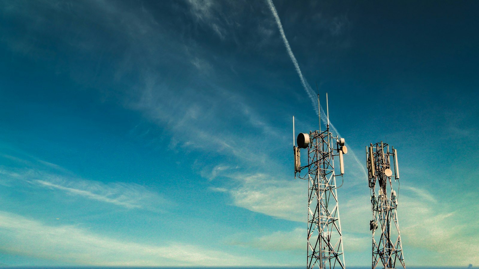 Mobile phone tower against a blue sky