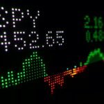 Digital stock market ticker display with a green trend line