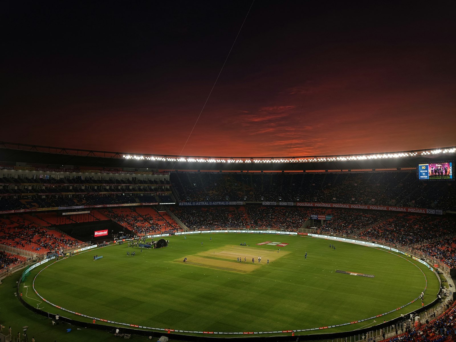 Cricket stadium with a green pitch