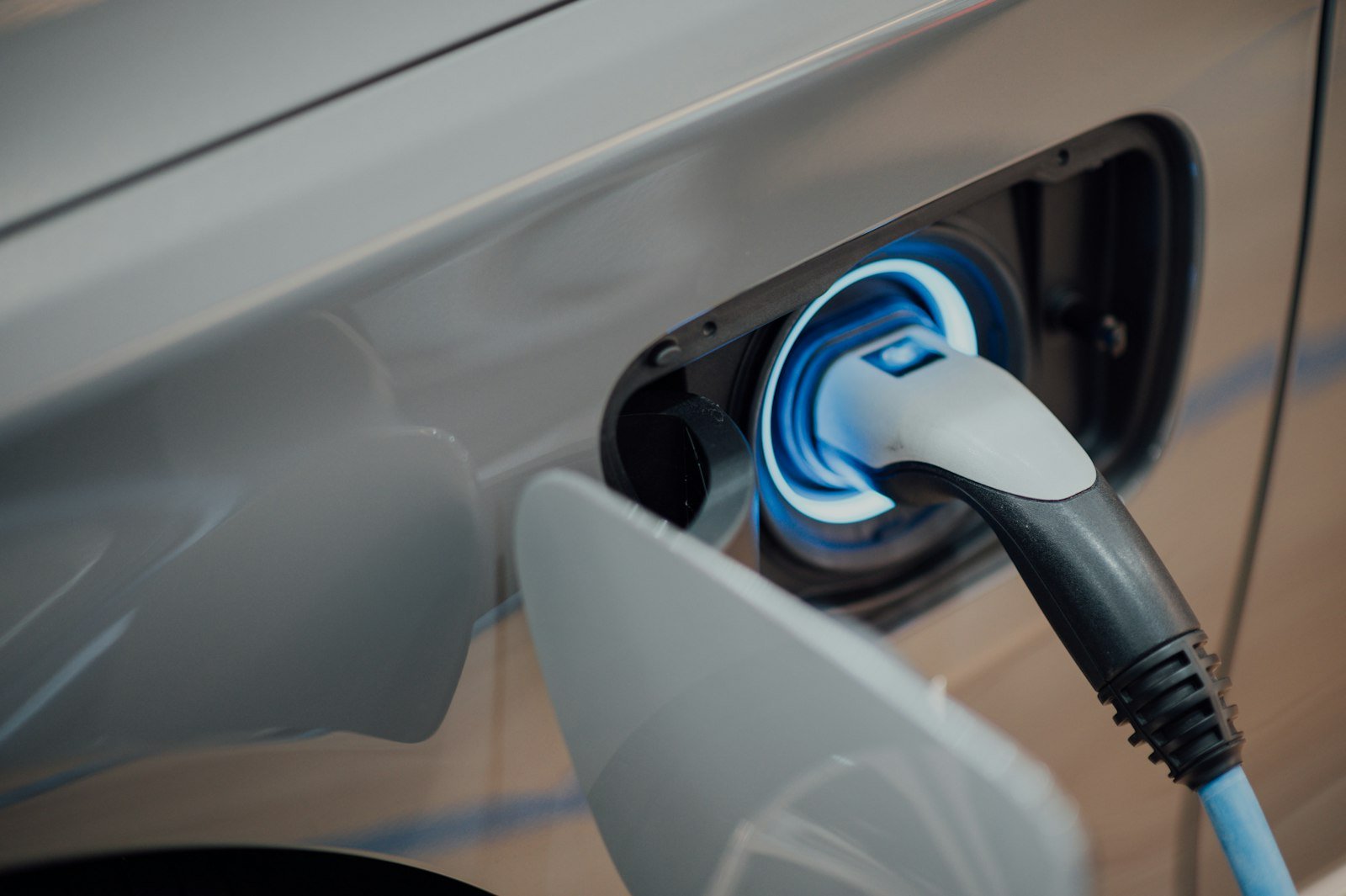 Electric vehicle charger plugged into a car