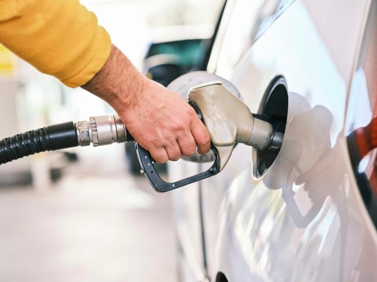 Person filling a car at a fuel station