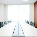 Empty modern office with a long table and chairs